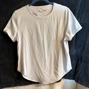 Under Armour size medium whit workout shirt. Cute back cut out.